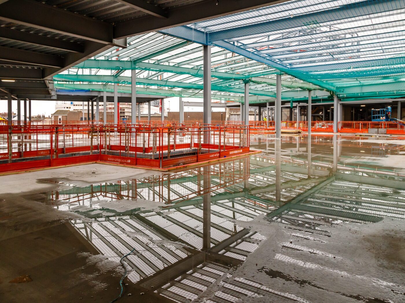 Arndale Centre Eastbourne construction site rainbow colours reflected in puddles